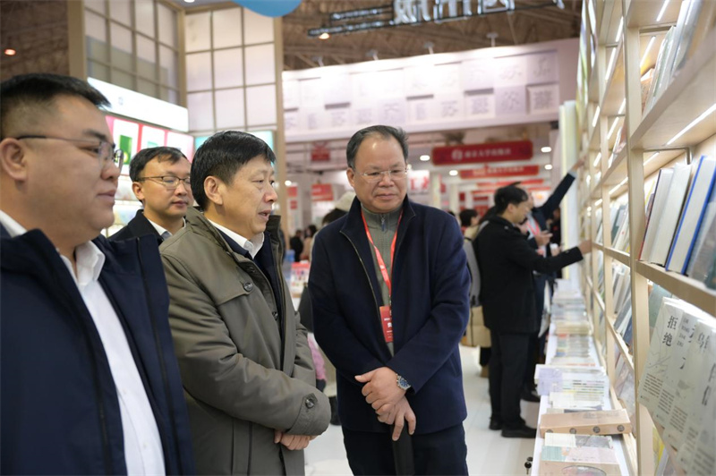 自治區(qū)黨委宣傳部副部長(zhǎng)利來友（中）視察集團(tuán)公司展位 秦念 攝.jpg